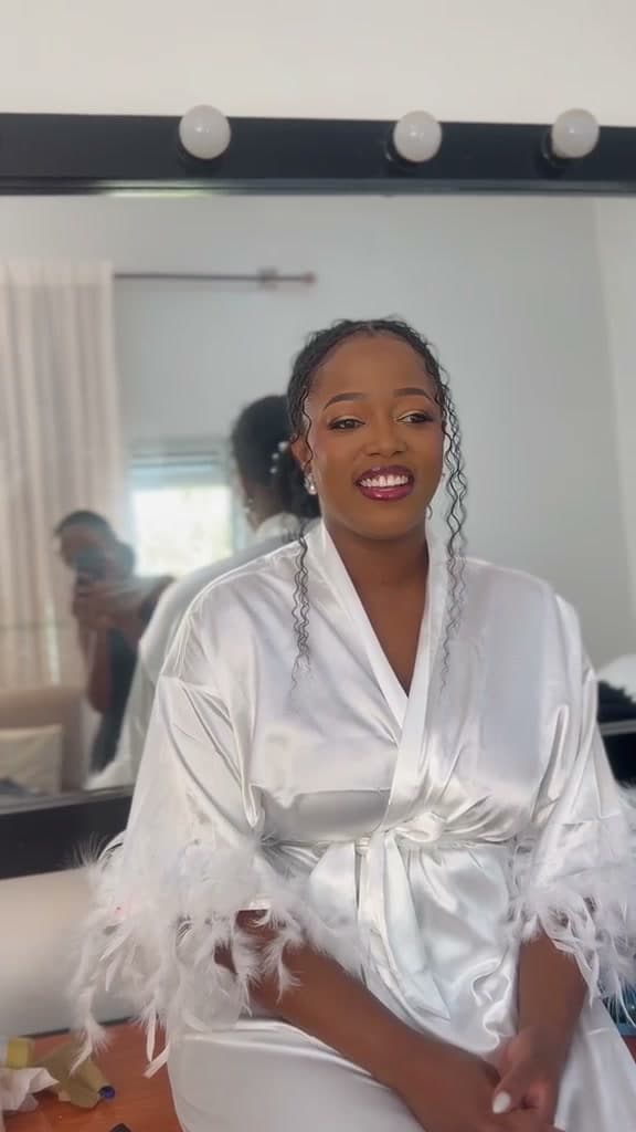 The same client in a white robe, finished and smiling